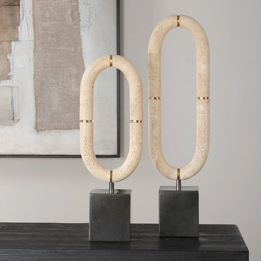 Oval Sculptures Fusion (Set of 2) by Uttermost in dark bronze. Made from steel, faxu travertine resin in a unique style.
