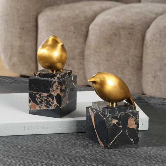 Finch Bird Figurines by Uttermost in black, brass and brass. Made from marble, brass in a unique style.
