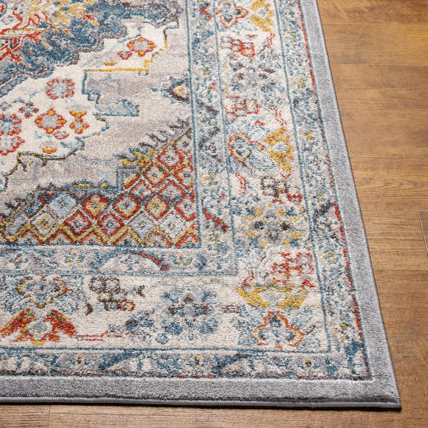 004 SI-2167436,SI-2167437 | Closeup | Ankara Rug by Livabliss in gray, taupe, ice blue, dark blue, cream, rust. Made from polypropylene in a unique style.