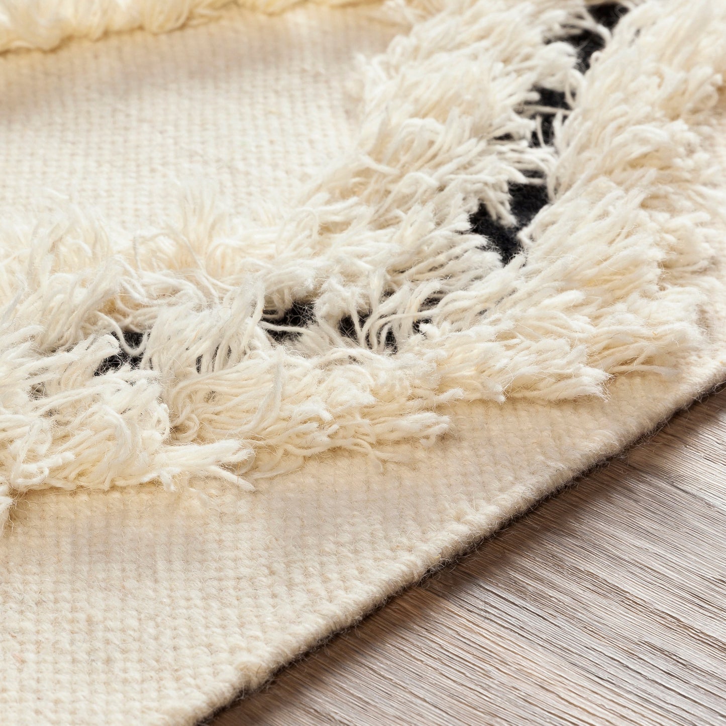 006 SI-1842710,SR-755344,SR-755345,SR-755346,SR-755348,SR-755349 | Closeup | Apache APA-2300 Rug by Livabliss in cream, black. Made from 100% wool in a unique style.