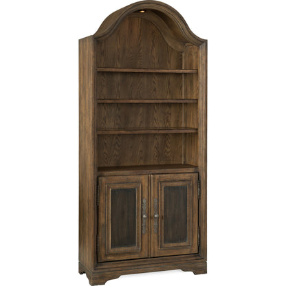 Pleasanton Bookcase by Hooker Furniture in saddle brown. Made from white oak veneers, glass, resin in a traditional style.