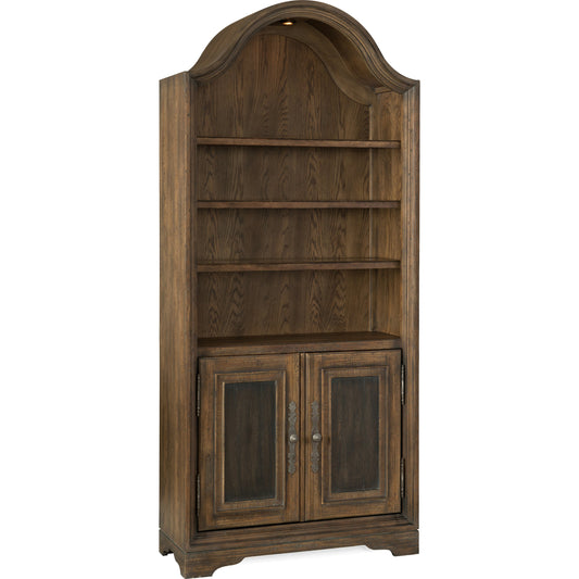 Pleasanton Bookcase by Hooker Furniture in saddle brown. Made from white oak veneers, glass, resin in a traditional style.