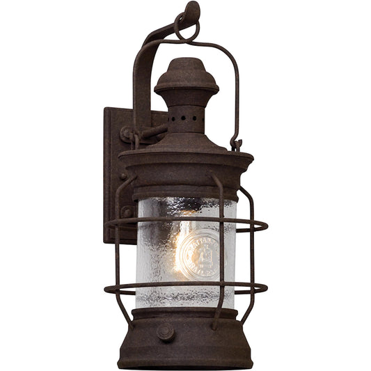 Atkins Wall Lantern by Troy in centennial rust. Made from hand worked iron, aluminum in a traditional style.
