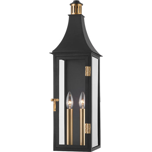 Wes Exterior Wall Sconce by Troy in patina brass. Made from aluminum in a traditional style.