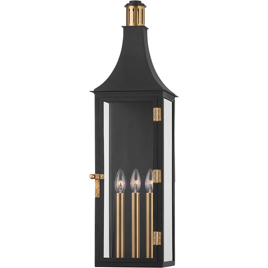 Wes Exterior Wall Sconce by Troy in patina brass. Made from aluminum in a traditional style.