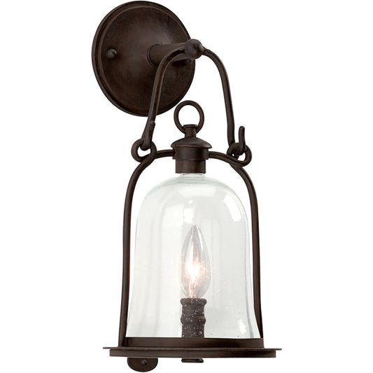 Owings Mill Wall Lantern by Troy in natural bronze. Made from hand forged iron in a traditional style.