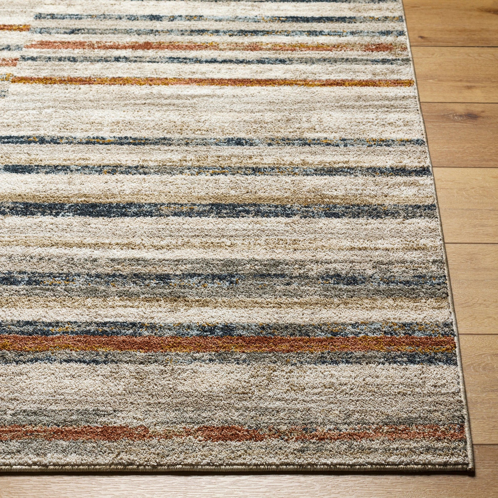 Beckham Rug - 33083 by Livabliss in light slate, off-white, charcoal, medium brown, ice blue, amber. Made from main: 100% polyester in a unique style.