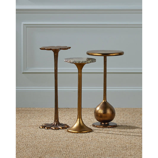 Carillon Accent Table by Currey and Company in antique brass. Made from cast aluminum in a rustic style.
