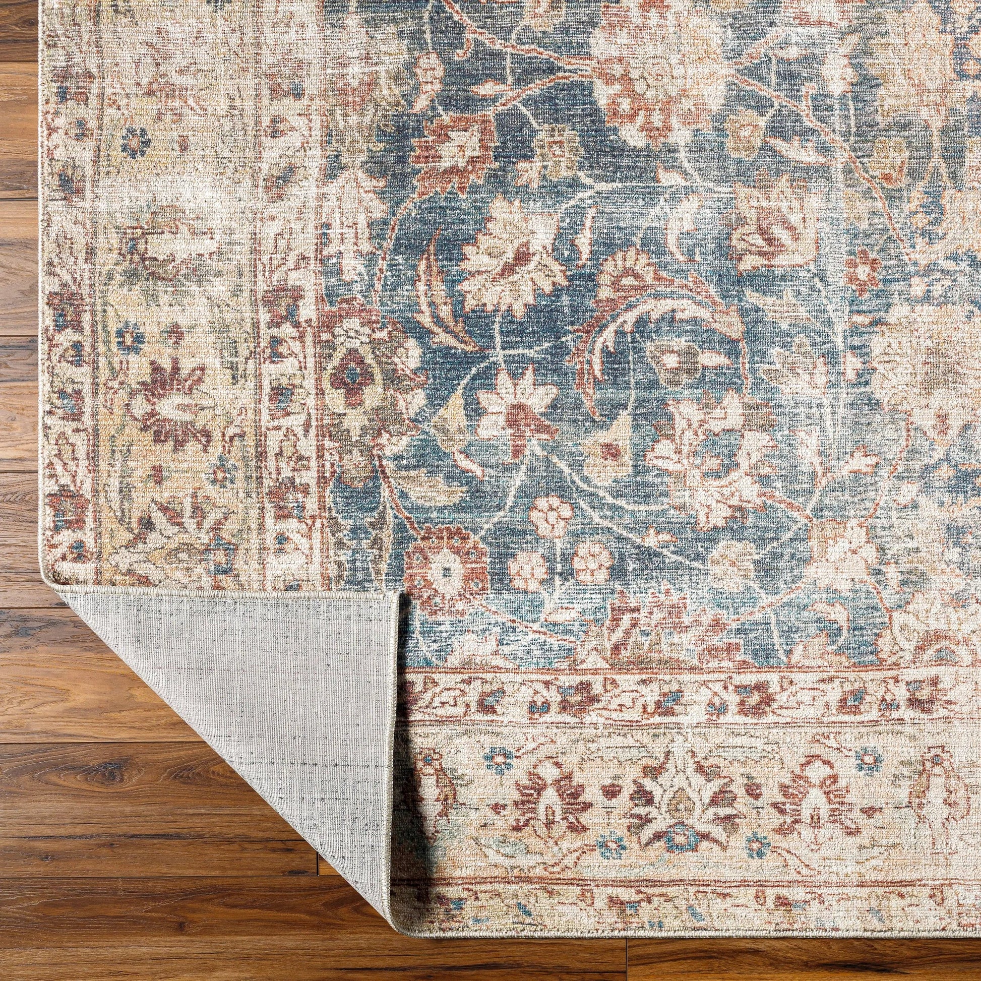 Marlene Rug - 490055 by Becki Owens x Livabliss in ink blue, ivory, tan, rust, brown, dark green. Made from face: 100% polyester, warp: 100% cotton in a