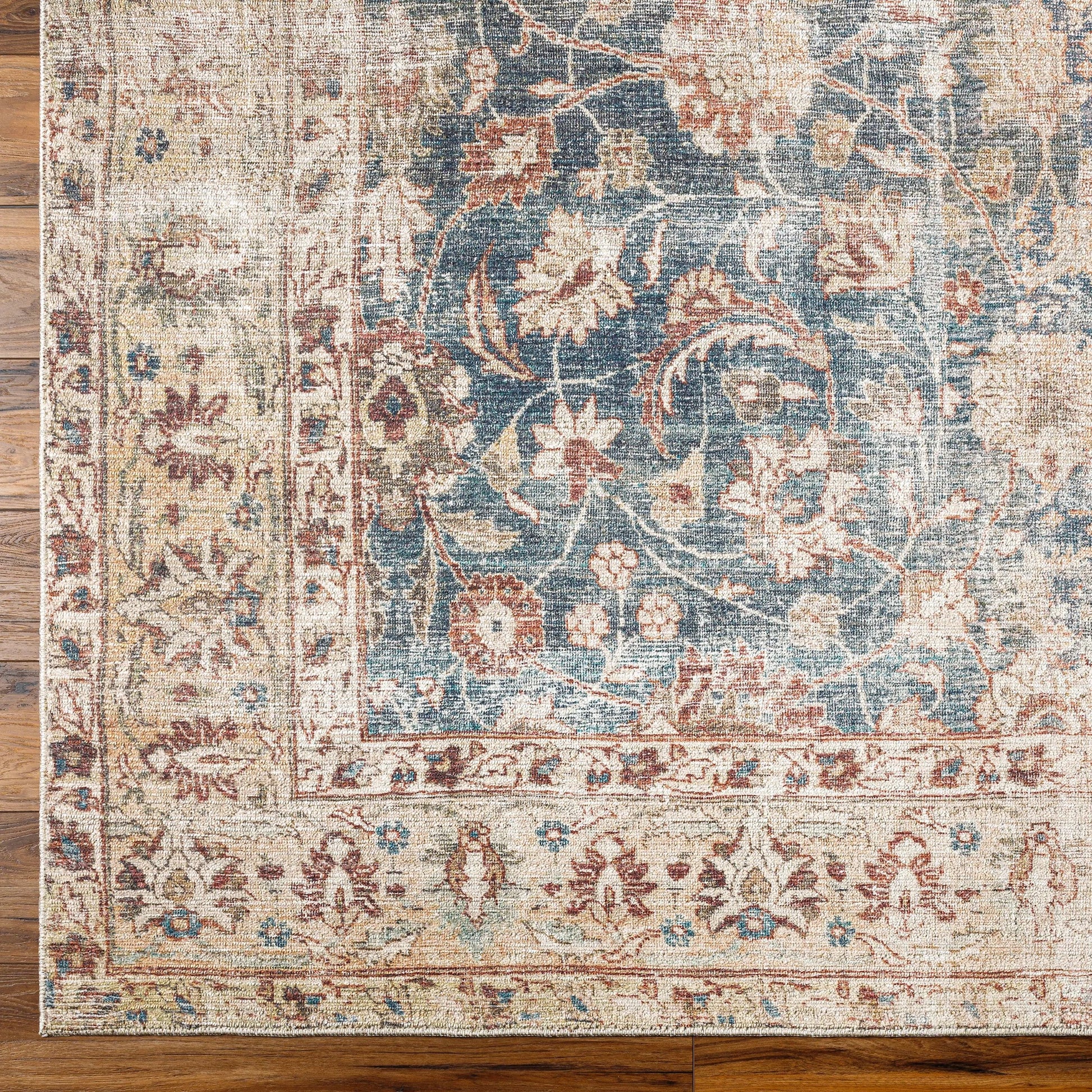Marlene Rug - 490055 by Becki Owens x Livabliss in ink blue, ivory, tan, rust, brown, dark green. Made from face: 100% polyester, warp: 100% cotton in a