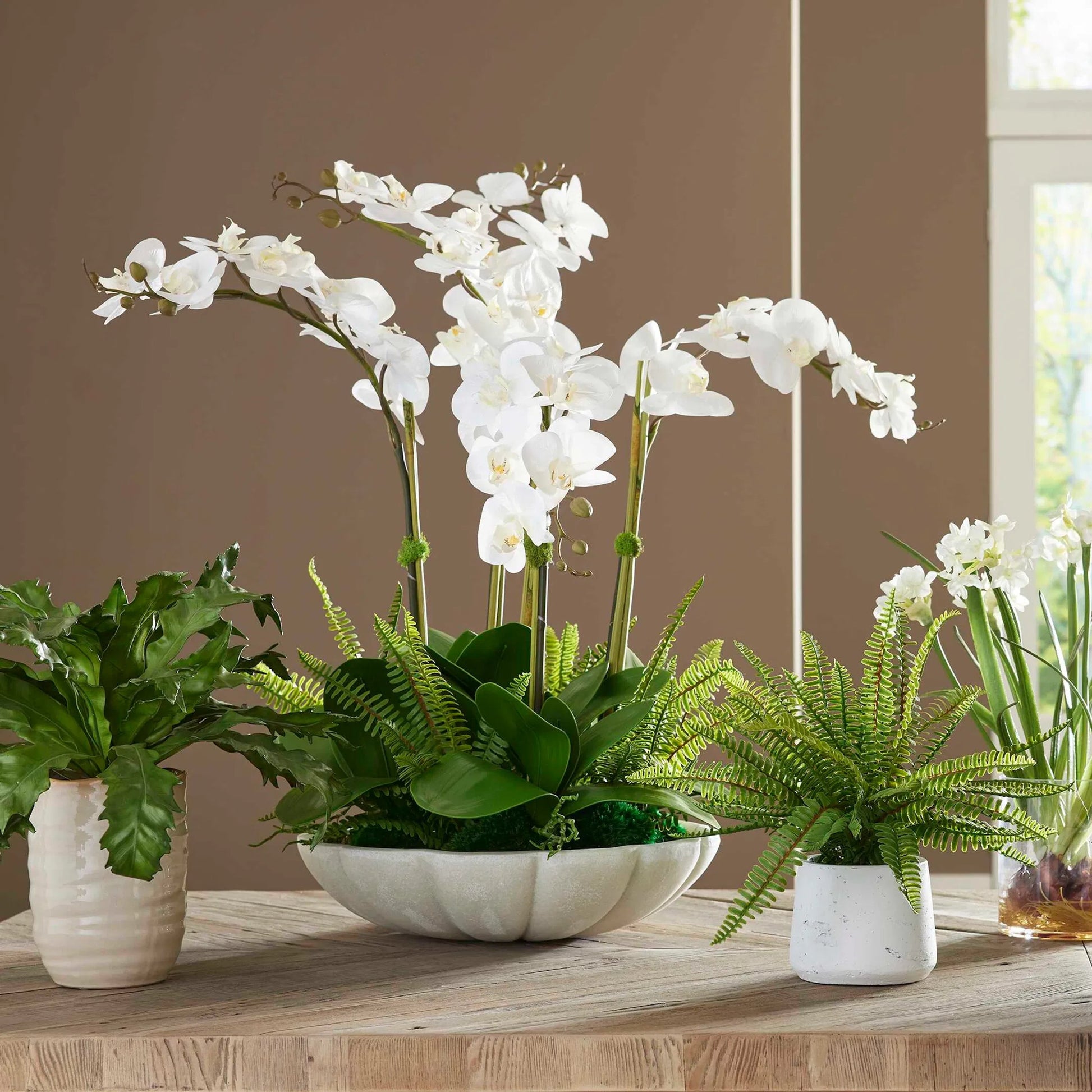 Flourish Orchid Centerpiece by Uttermost in white. Made from ricestone, fabric, latex, foam, ba in a transitional style.