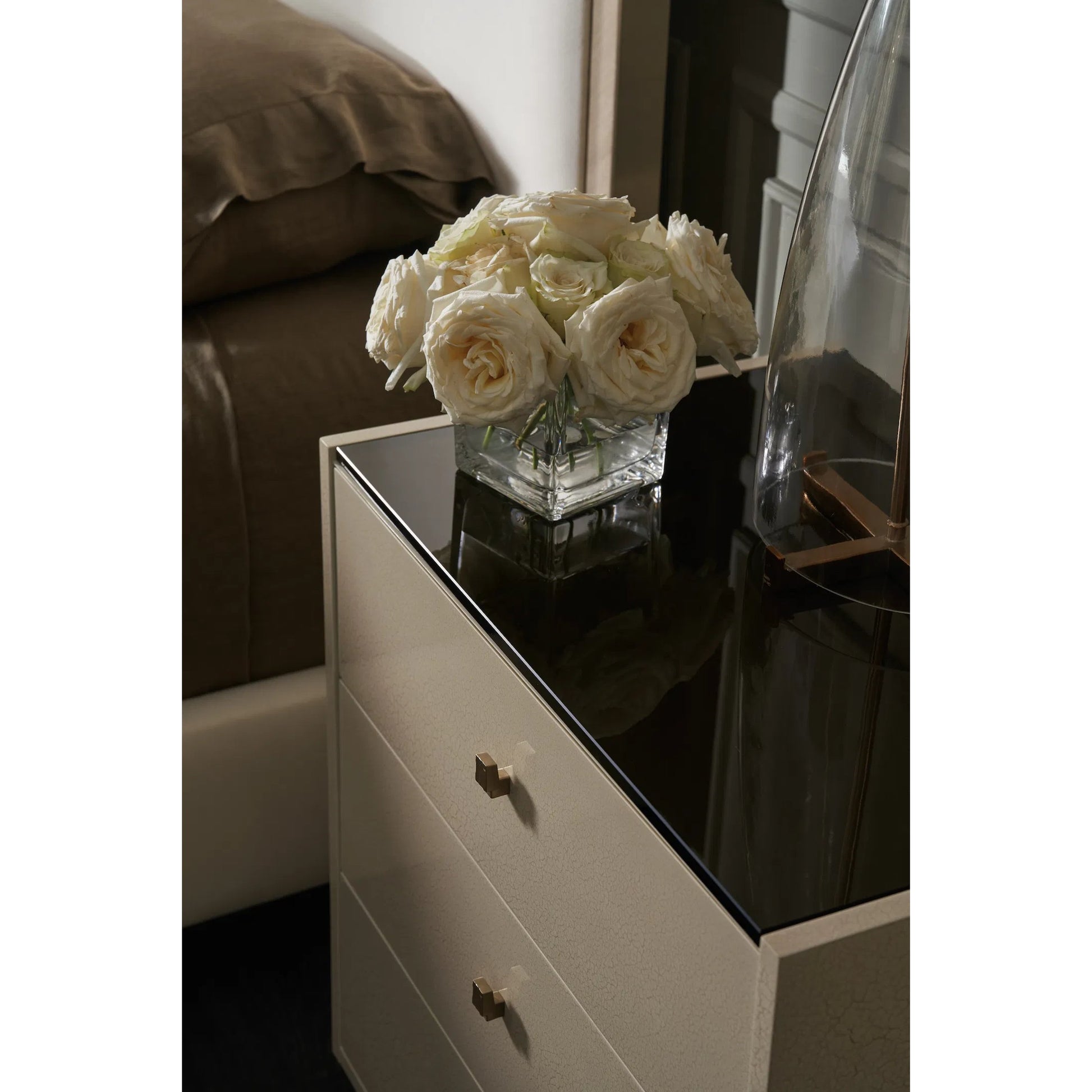 Iliad Nightstand by Caracole in ivory, smoked, bronze, gold and ivory craze, brushed gold paint. Made from poplar, koto, glass in a unique style.