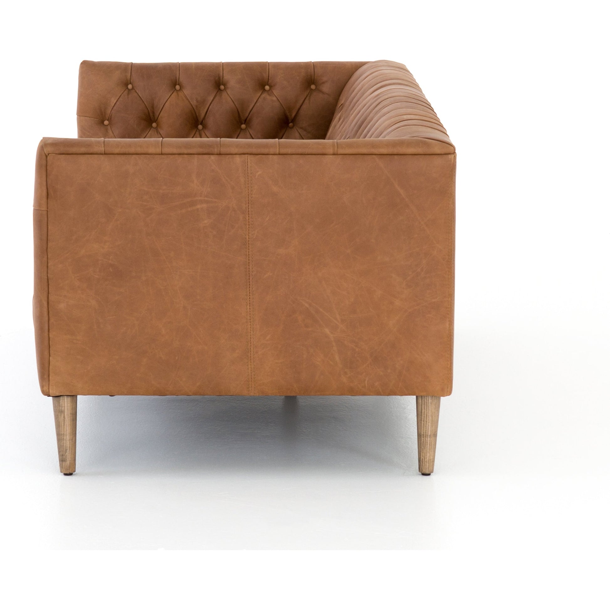 Williams Leather Sofa by Four Hands. Made from top grain leather, solid ash, 100% polyester in a rustic style.