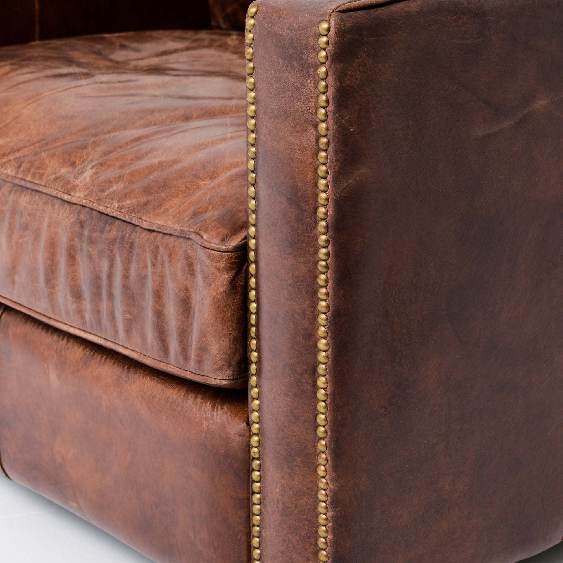Larkin Club Chair by Four Hands in cigar and antique oak, antique brass nailhead. Made from top grain leather, solid ash, iron in a modern style.