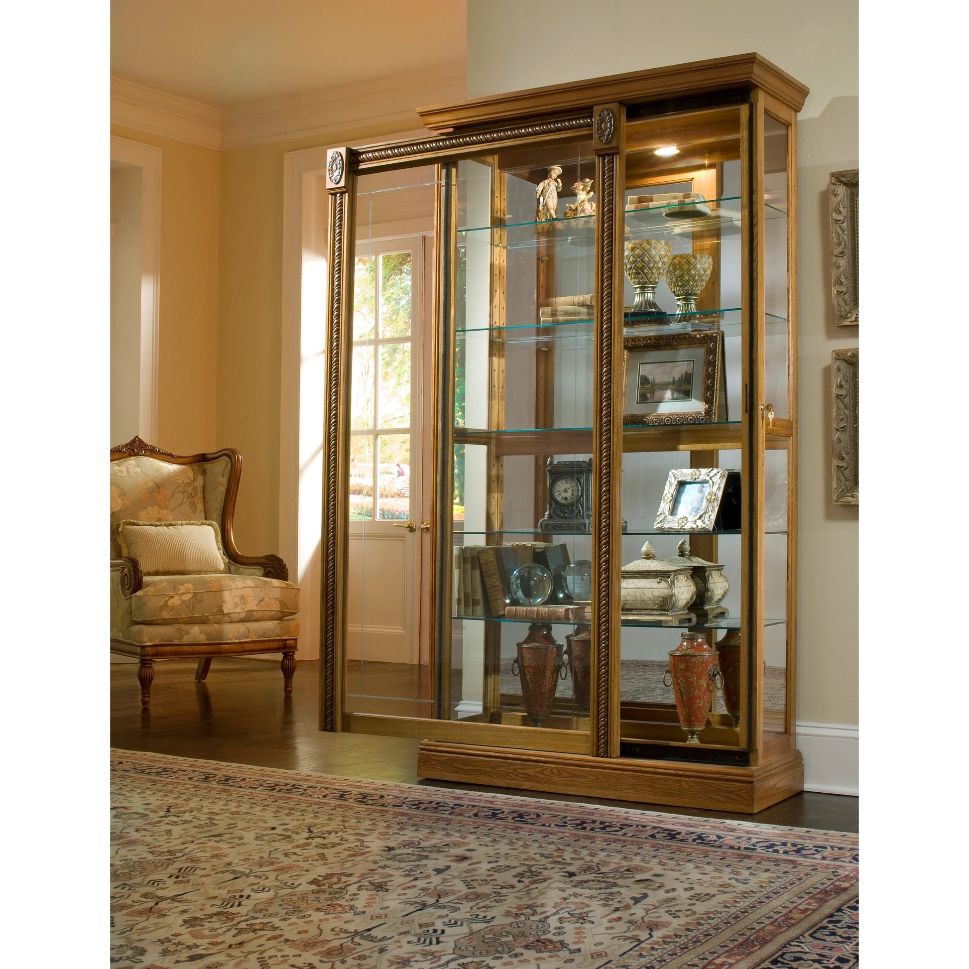 43'' Wide Hardwood Two Way Sliding Door Curio Cabinet in Warm Honey by Pulaski Furniture in warm honey-tone. Made from hardwood solids in a traditional style.