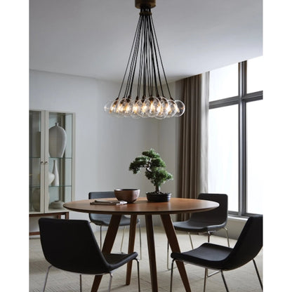 Gambit Multi-Port Chandelier by Tech Lighting in aged brass. Made from glass in a modern style.