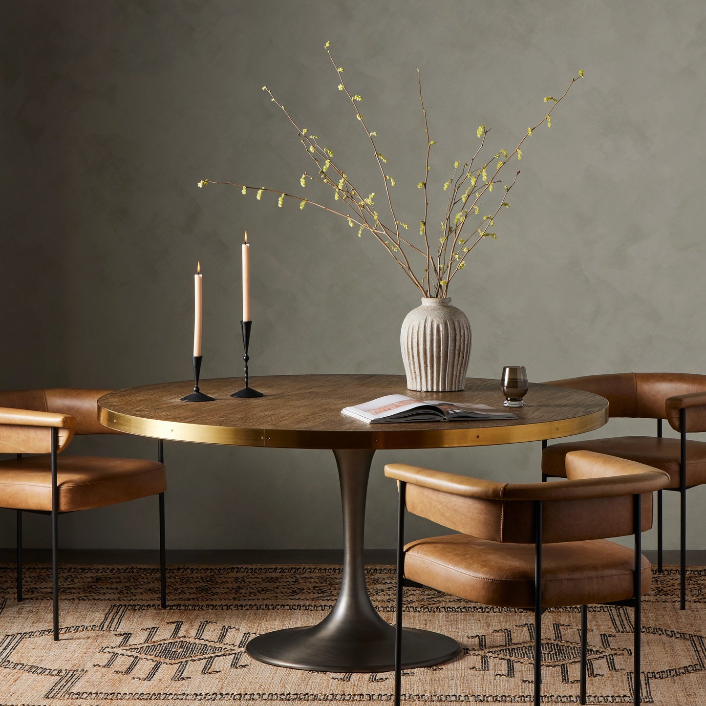 007 S-338899 | Lifestyle | Evans Round Dining Table by Four Hands in reclaimed burnt oak, vessel grey, polished brass. Made from solid reclaimed oak, iron, stainless steel in a modern style.