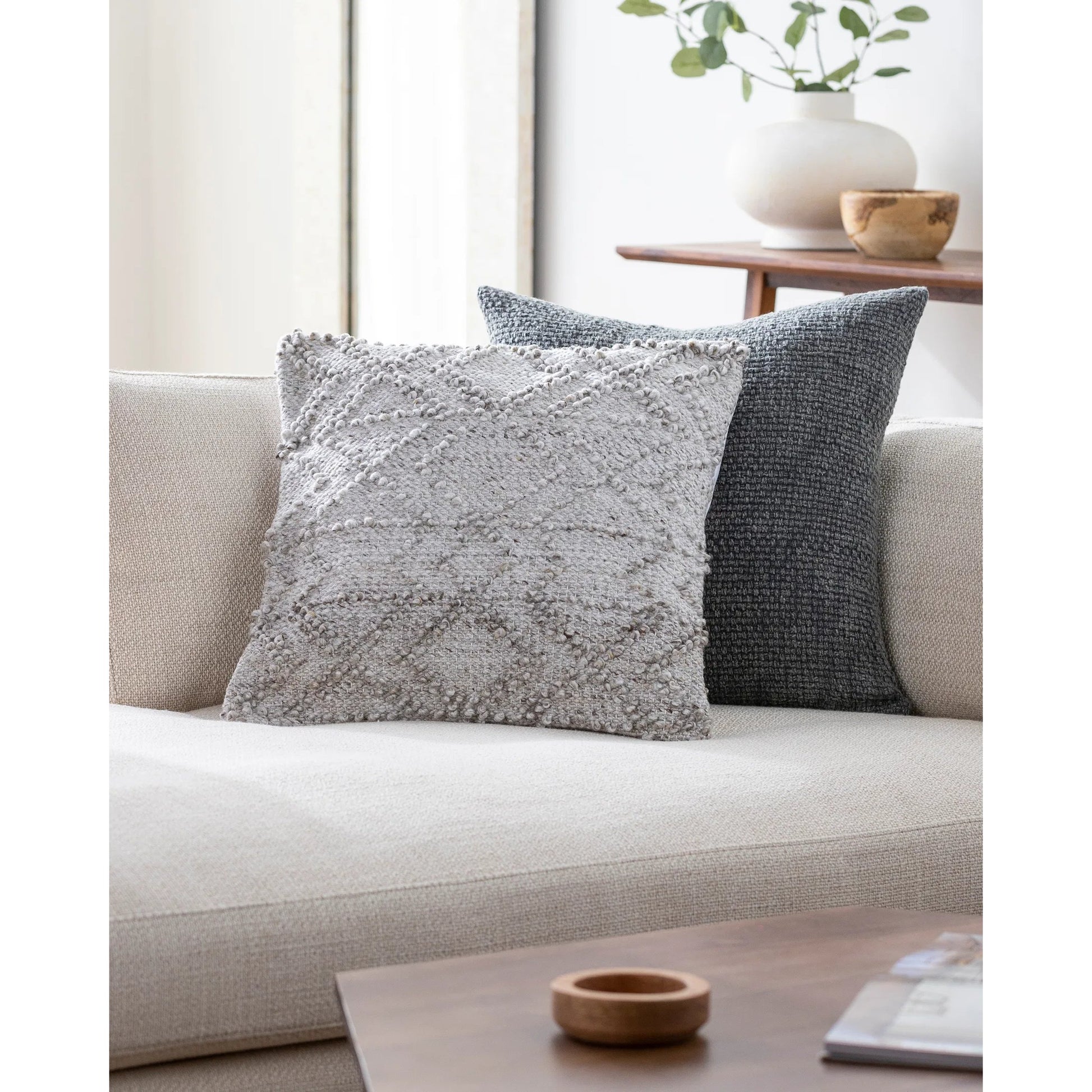 Chrisley Indoor/Outdoor Pillow by Livabliss in light silver, off-white, light grey, ash. Made from front: 100% polyester, back: 100% polyester in a modern style.