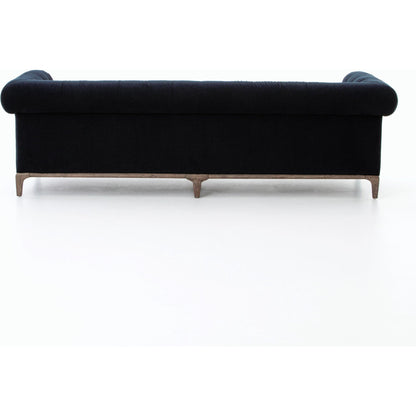 Griffon Sofa by Four Hands in plush navy and plush navy, antique walnut. Made from 100% polyester, solid parawood in a modern style.