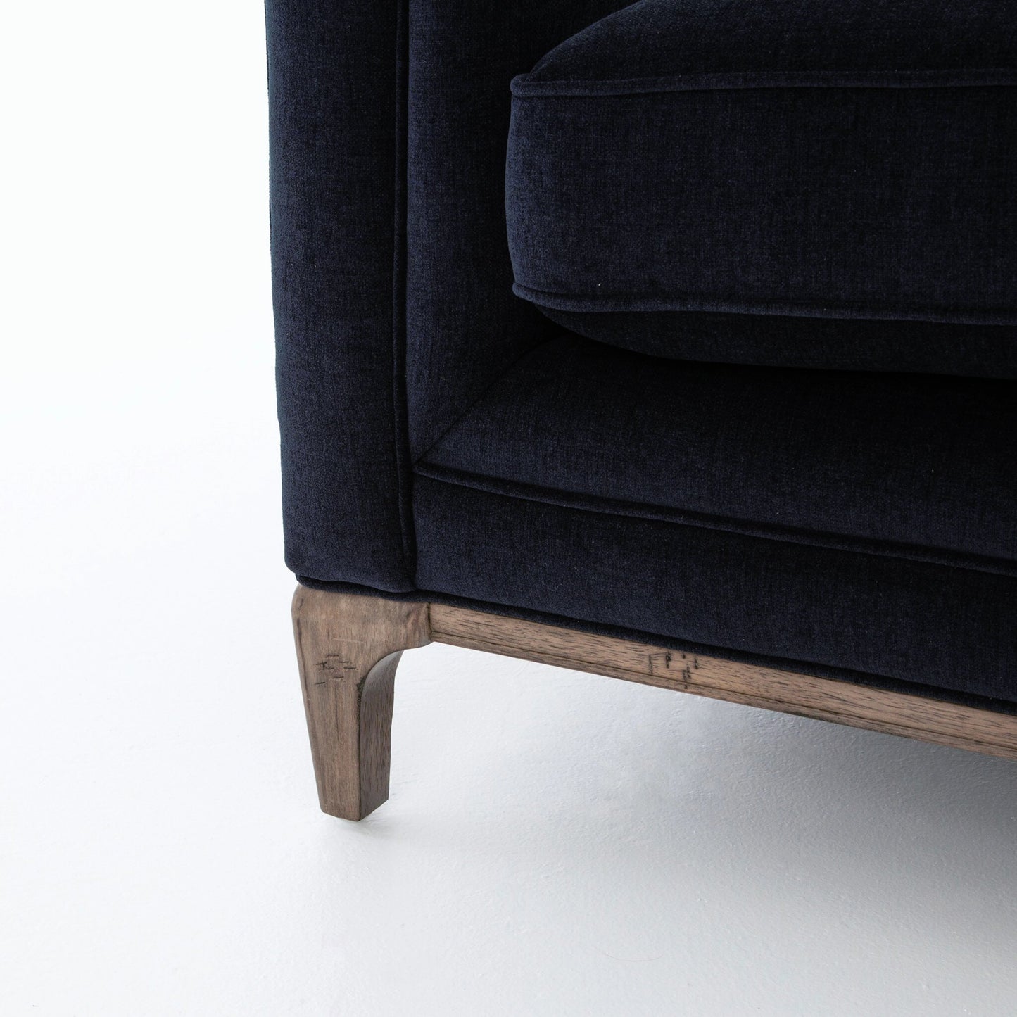 011 S-258325 | Closeup | Griffon Sofa by Four Hands in plush navy and plush navy, antique walnut. Made from 100% polyester, solid parawood in a modern style.
