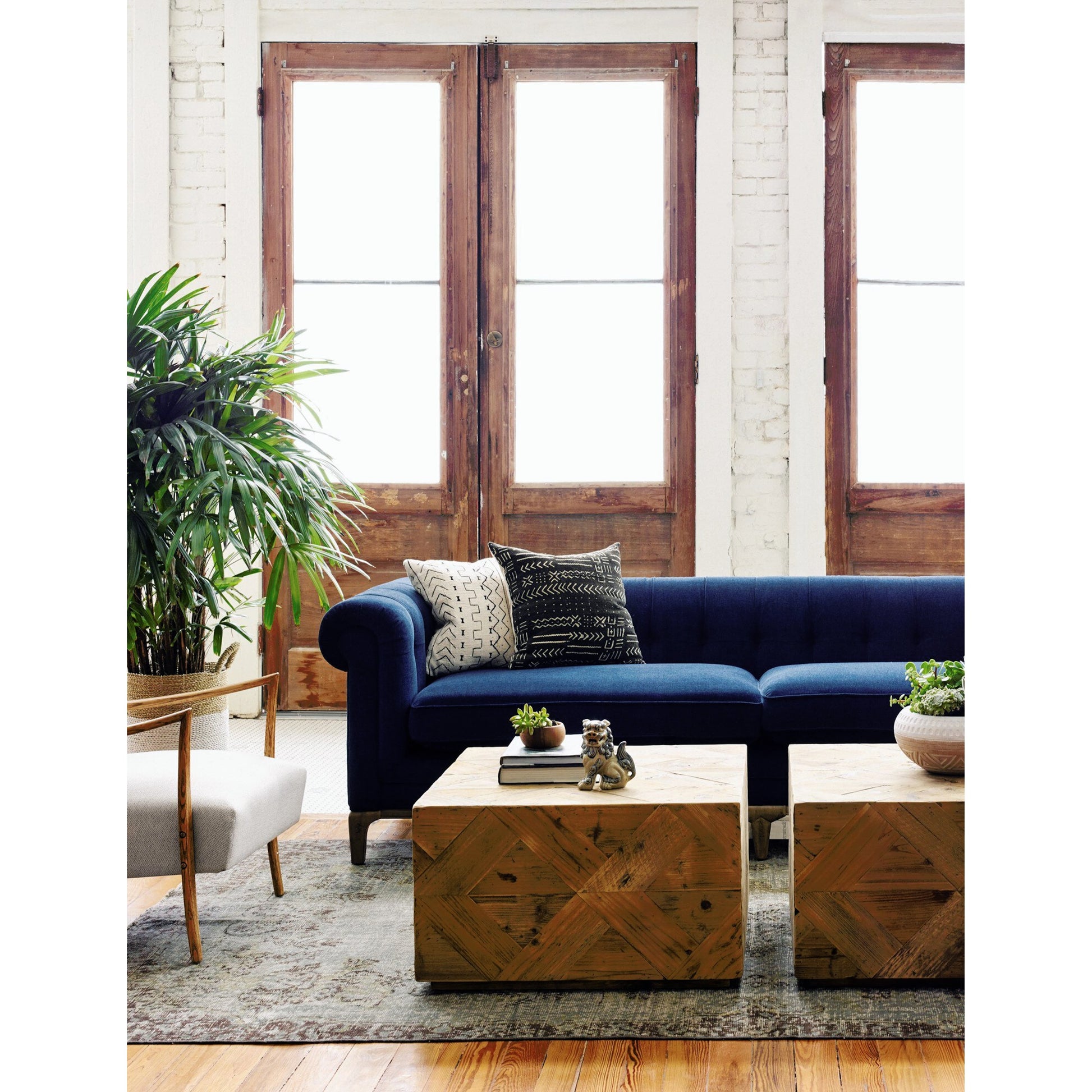 Griffon Sofa by Four Hands in plush navy and plush navy, antique walnut. Made from 100% polyester, solid parawood in a modern style.