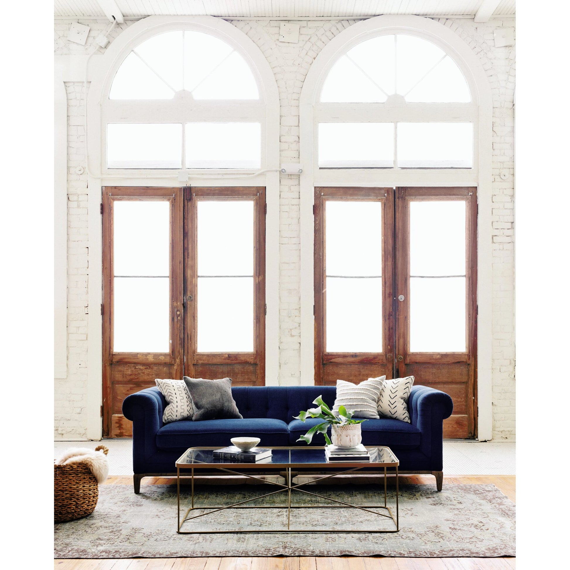 Griffon Sofa by Four Hands in plush navy and plush navy, antique walnut. Made from 100% polyester, solid parawood in a modern style.