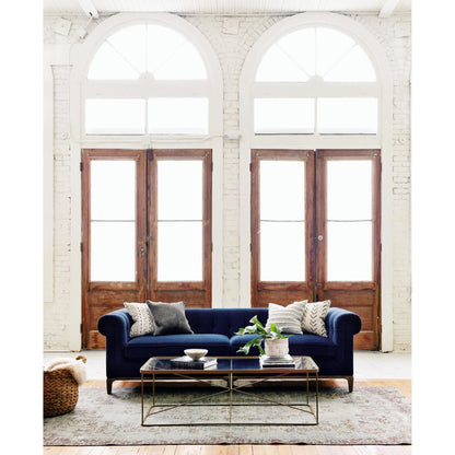 Griffon Sofa by Four Hands in plush navy and plush navy, antique walnut. Made from 100% polyester, solid parawood in a modern style.