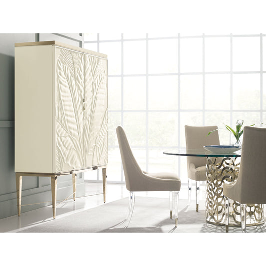 Palms Up! Bar Cabinet by Caracole in gold, ivory and wedding dress white, soft taupe, whisper of gold. Made from pine solids, pine veneers, metal in a transitional style.