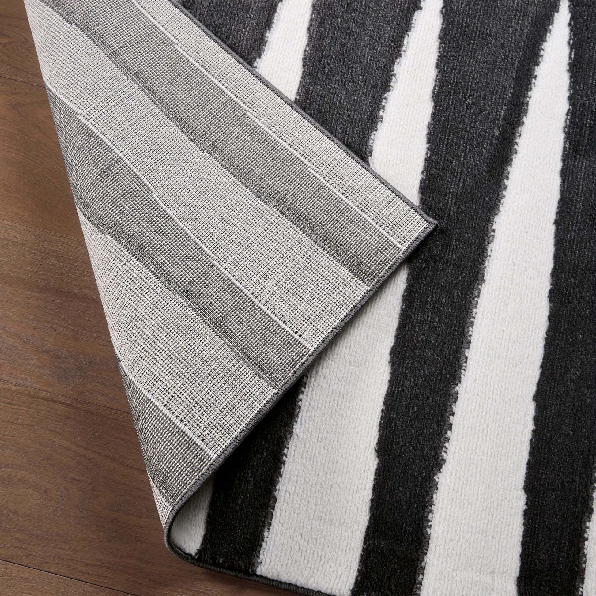 Calix by Nikki Chu CNU01 Rug by Jaipur Living in black, white. Made from 70% polypropylene 30% polyester in a unique style.