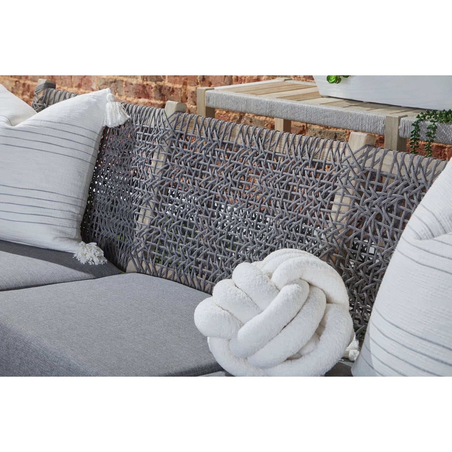 019 SI-2072278 | Closeup | Costa Sofa by Essentials For Living in gray teak, performance dove. Made from solid teak wood, polyolefin rope, 100% olefin fabric, foam in a coastal style.