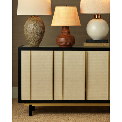 Deanna Raffia Credenza by Currey and Company in ivory, black, satin brass, natural, clear. Made from raffia, okume veneer, stainless steel, sycamore veneer, tempered glass in a modern style.