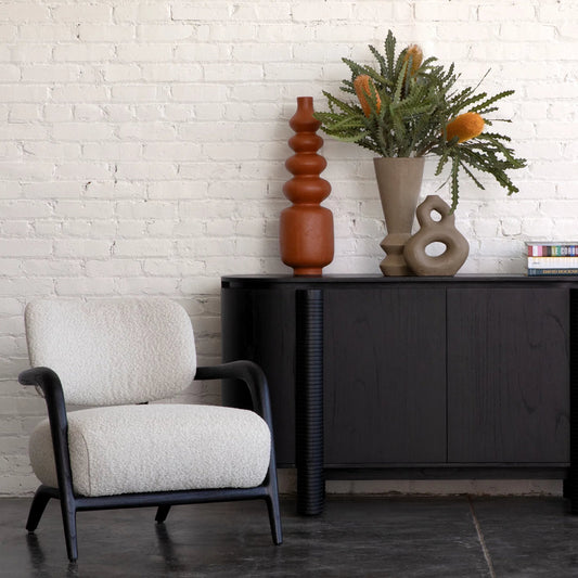 Arcona Occasional Chair by Arch & Plane in black wood, ivory boucle upholstery. Made from mindi wood frame, boucle upholstery in a unique style.