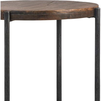 Darion Side Table by Arch & Plane in antique medium brown wood, black iron legs. Made from mango wood, forged steel base in a traditional style.