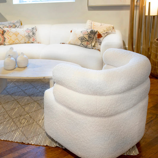 Regan Ivory Faux Sheepskin Swivel Club Chair by Arch & Plane in ivory and fabric. Made from faux sheep skin in a modern style.
