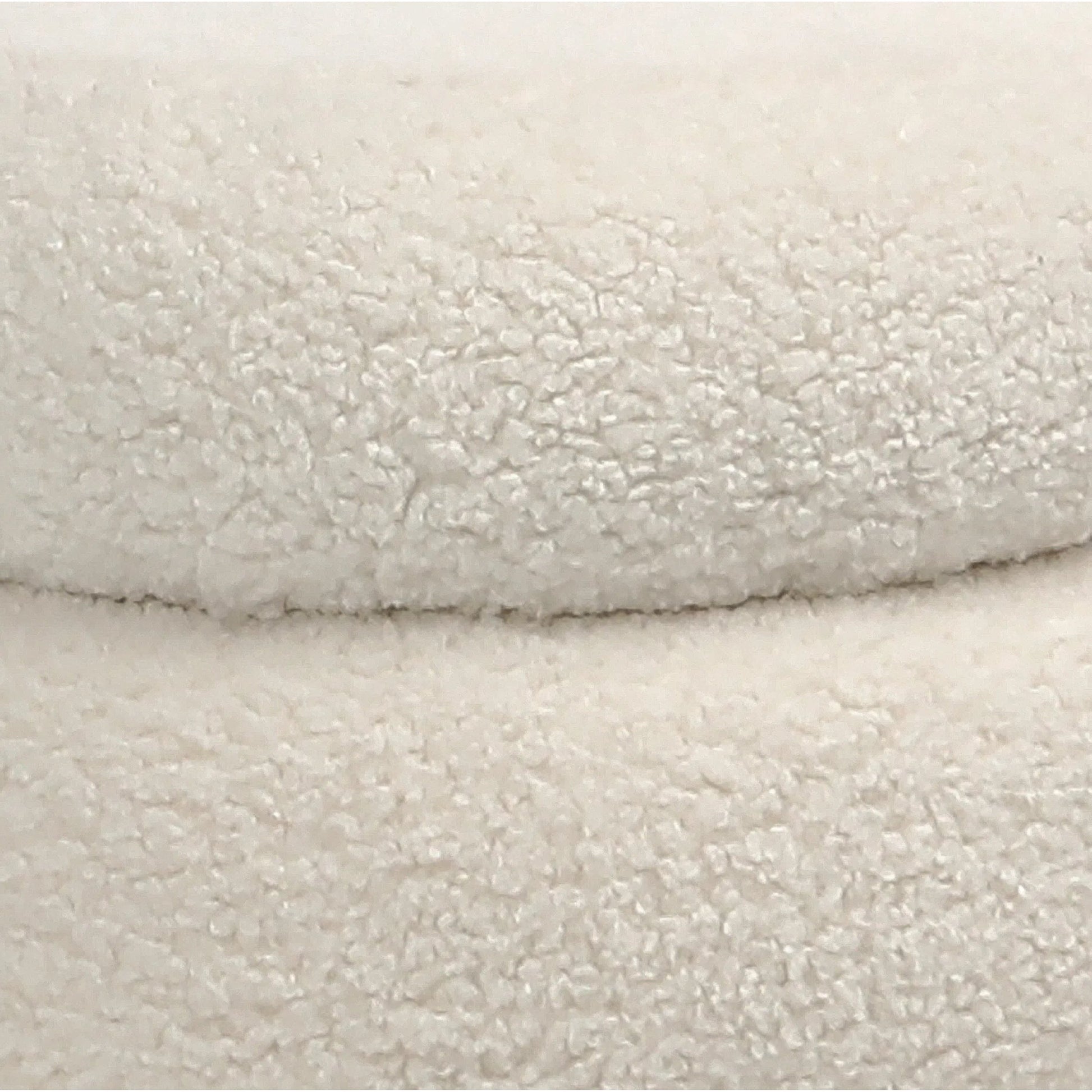 Terri Ivory Faux Sheepskin Ottoman by Arch & Plane in ivory and upholstered. Made from faux sheepskin in a modern style.