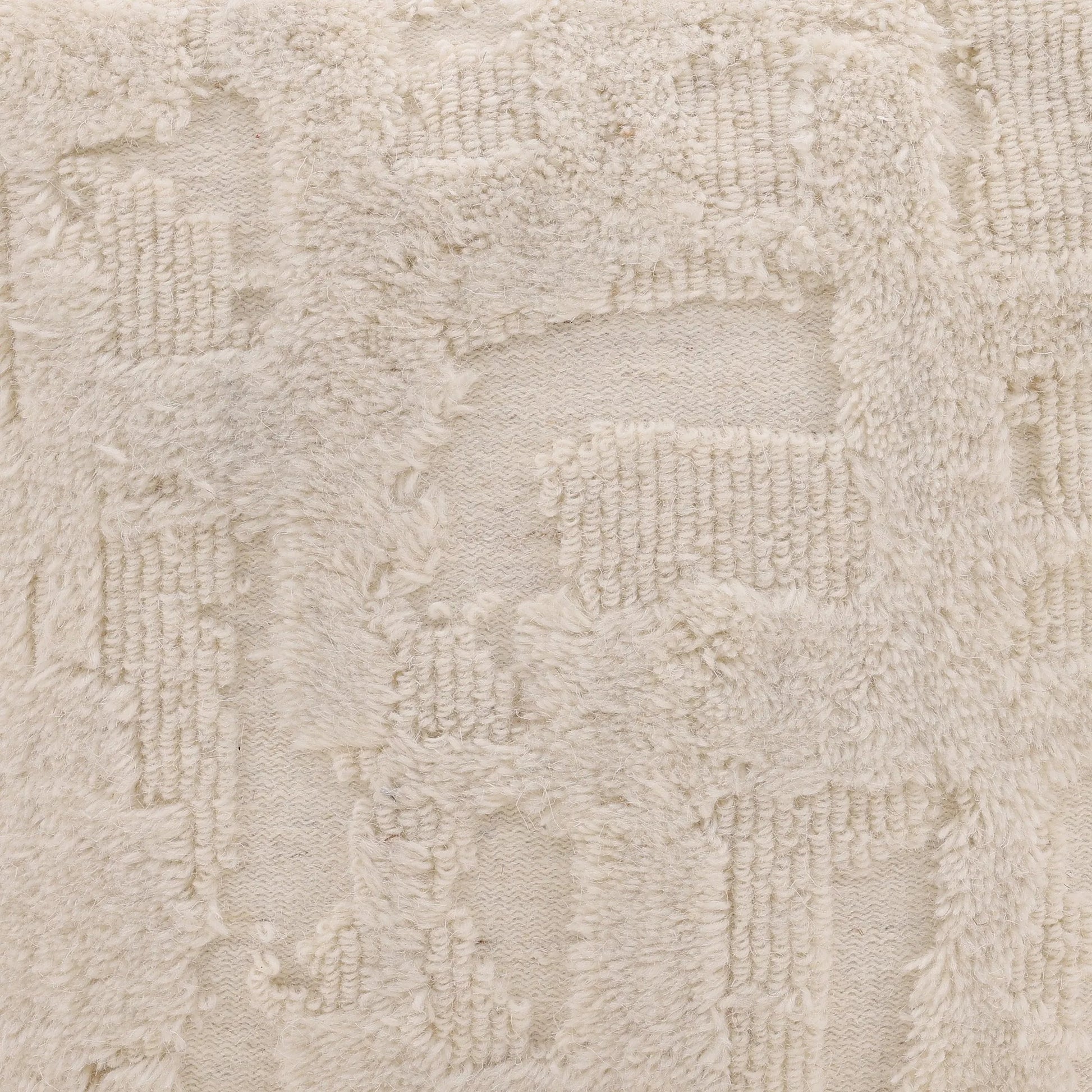 Winter Pouf by Arch & Plane in ivory. Made from handwoven wool in a rustic style.