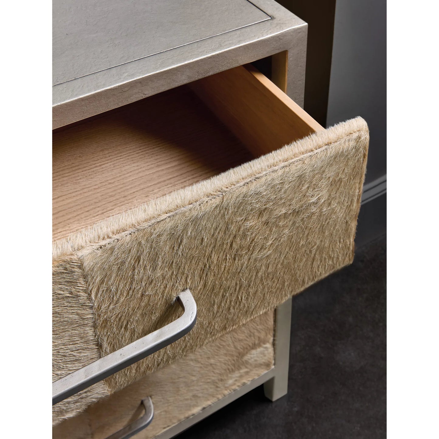 003 SI-2458422 | Closeup | Melange Holy Cow Chest by Hooker Furniture in silver metal, beige hair on hide leather. Made from wood, metal, hair on hide leather in a transitional style.