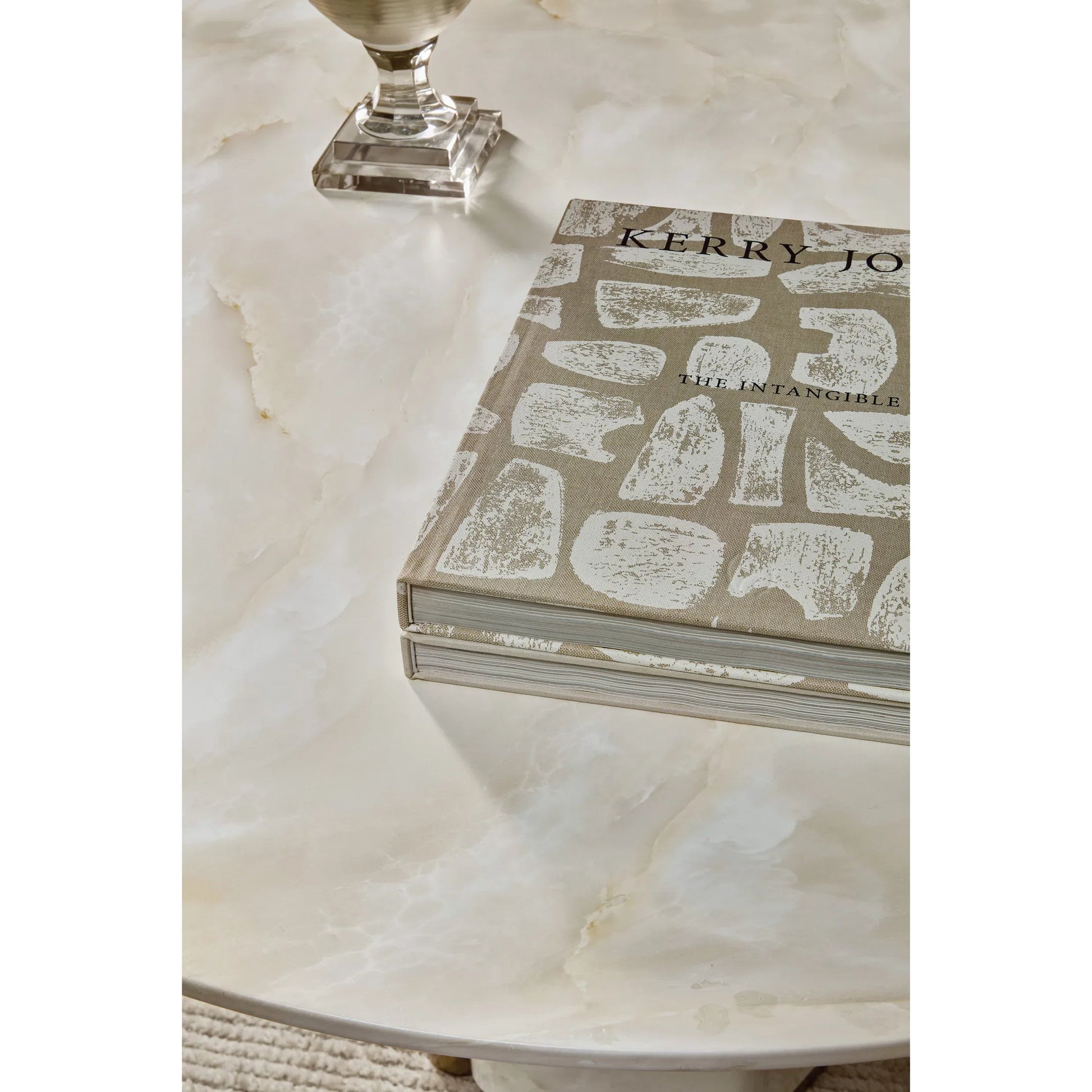 Eleana Round Dining Table by Hooker Furniture in faux onyx. Made from concrete, resin, metal in a modern style.