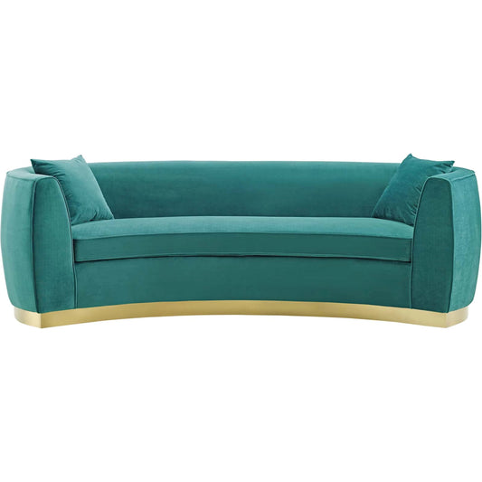 Marin Curved Sofa by Evans & Londeen in teal. Made from brushed stainless steel with golden color, foam in 2 layer 4in, 0.5in, 1 layer 200g polyester wadding, yuhua velvet, 100% polyester, 2 matching pillows, plywood, wood fr