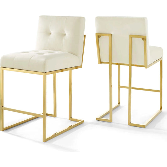 Pinal Gold Counter Stool (Set of 2) by Evans & Londeen in gold ivory. Made from yuhua velvet fabric, plywood, 2 layers of foam, stainless steel square tube chromed, polyester in a modern style.