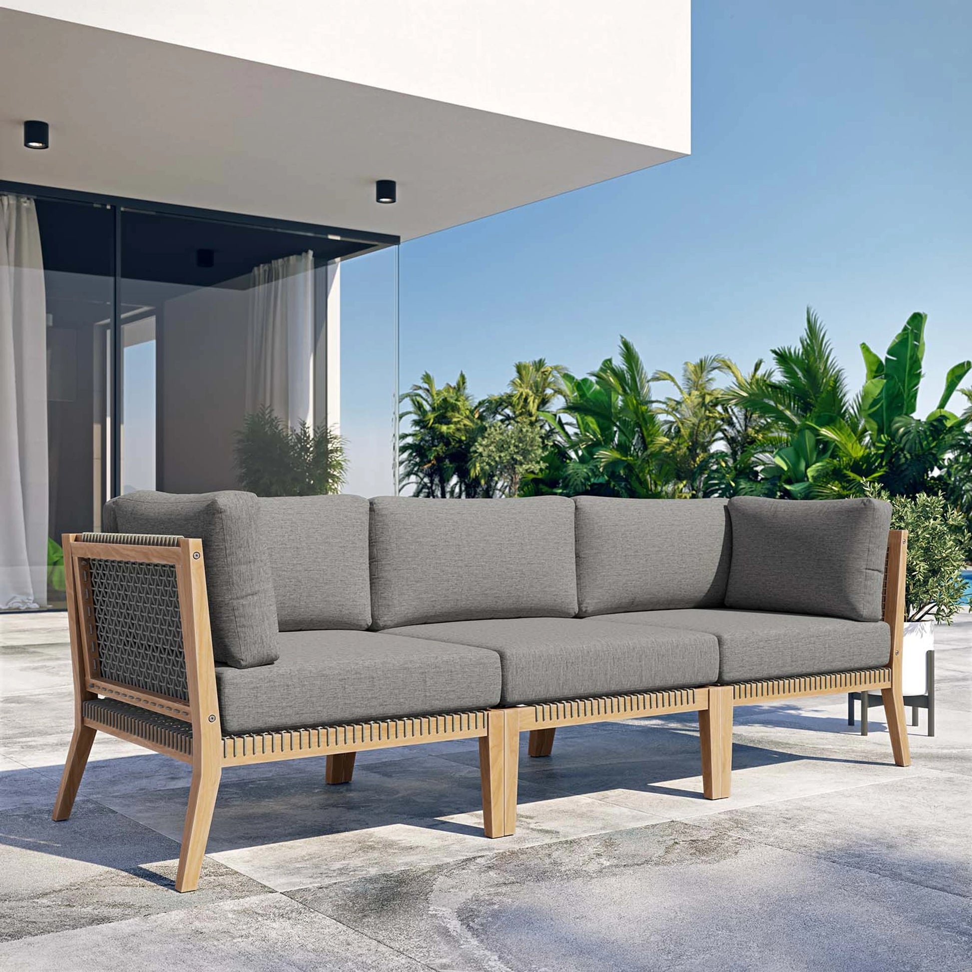 Cooper Teak Wood Sofa by Evans & Londeen. Made from teak wood, rope, quick dry foam, tack glides in a modern style.