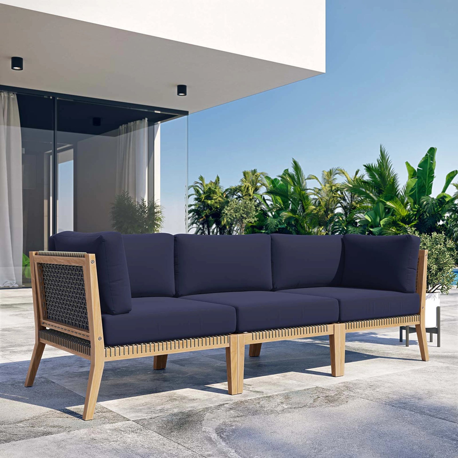Cooper Teak Wood Sofa by Evans & Londeen. Made from teak wood, rope, quick dry foam, tack glides in a modern style.