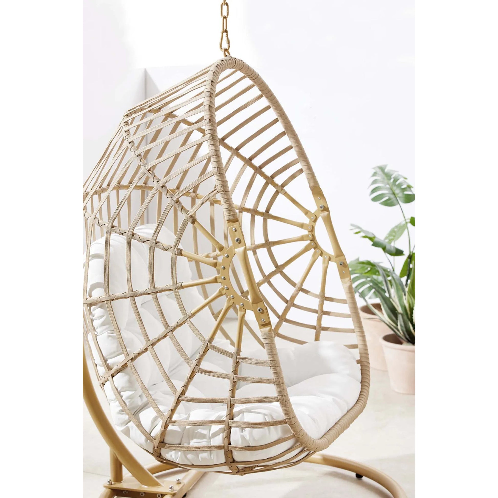 Gilmer Rattan Swing Chair by Evans & Londeen in natural white. Made from steel, rattan, rope, weimas white fabric, natural rattan #7x-302, stand, base in natural color mc03, spring holder, 2m chains (extra), 280mm chains in a cottage &