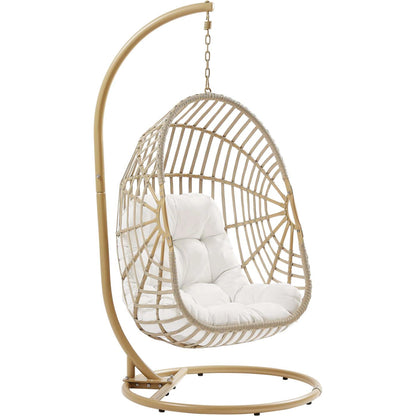 Gilmer Rattan Swing Chair by Evans & Londeen in natural white. Made from steel, rattan, rope, weimas white fabric, natural rattan #7x-302, stand, base in natural color mc03, spring holder, 2m chains (extra), 280mm chains in 