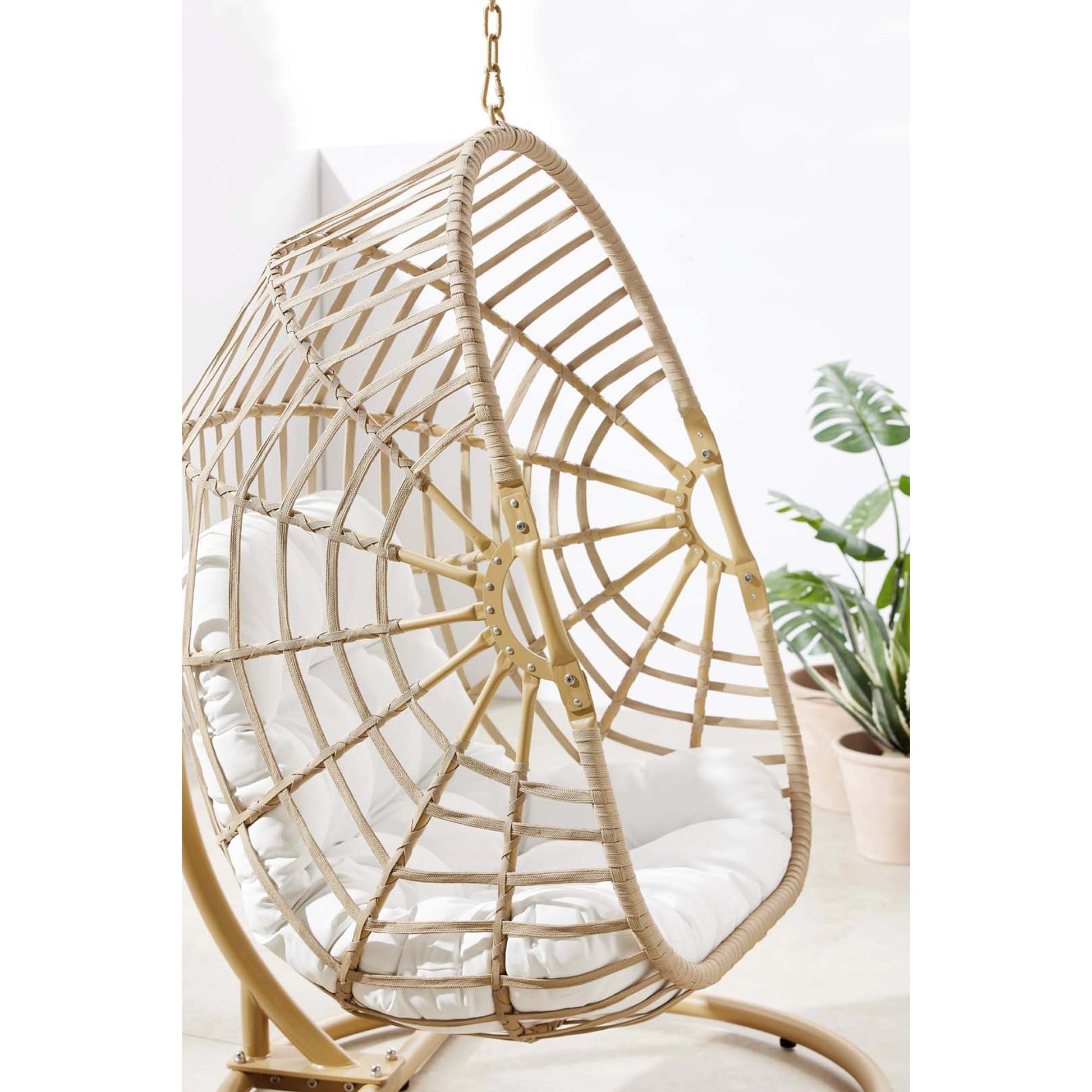 Gilmer Rattan Swing Chair by Evans & Londeen in natural white. Made from steel, rattan, rope, weimas white fabric, natural rattan #7x-302, stand, base in natural color mc03, spring holder, 2m chains (extra), 280mm chains in a cottage &