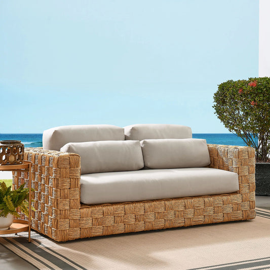 Frontier Outdoor Rattan Loveseat by Evans & Londeen in natural light gray. Made from rattan in a unique style.