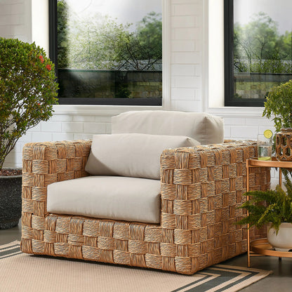 Volusia Rattan Armchair by Evans & Londeen in natural light gray. Made from rattan in a rustic style.