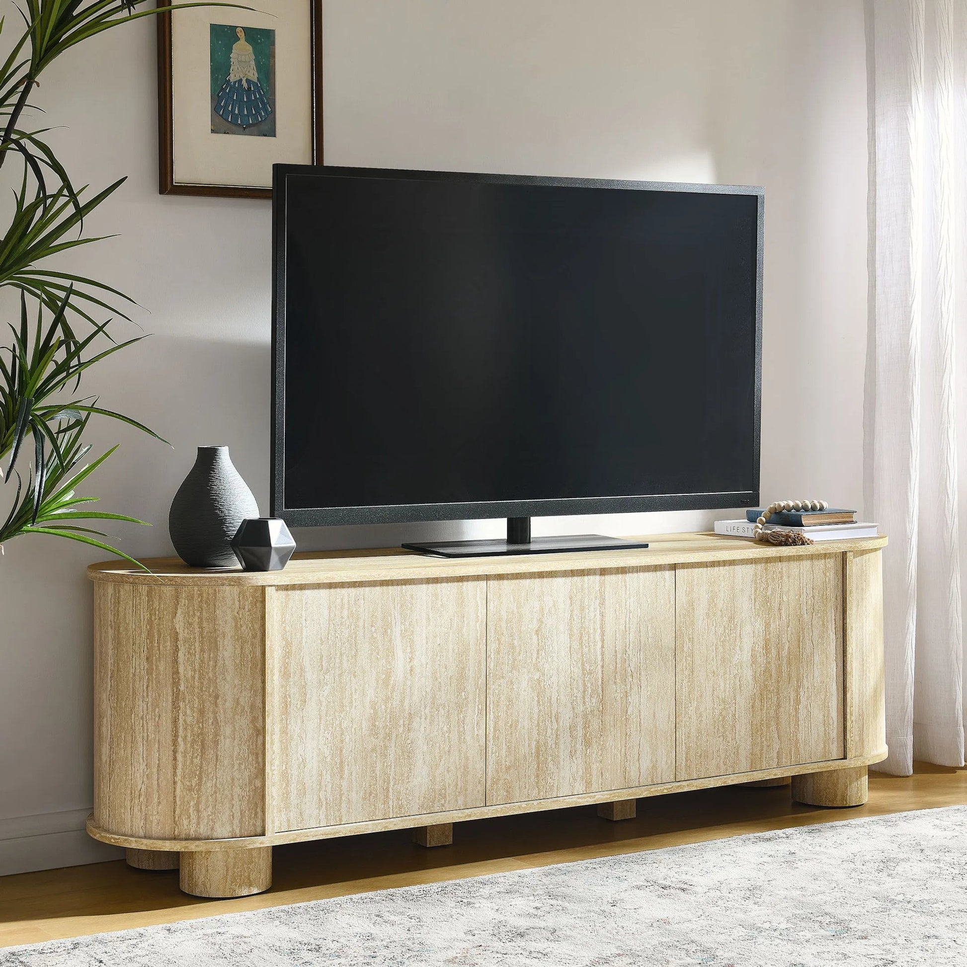 Dona 63” Oval Faux Travertine TV Stand by Evans & Londeen in travertine. Made from faux travertine in a transitional style.