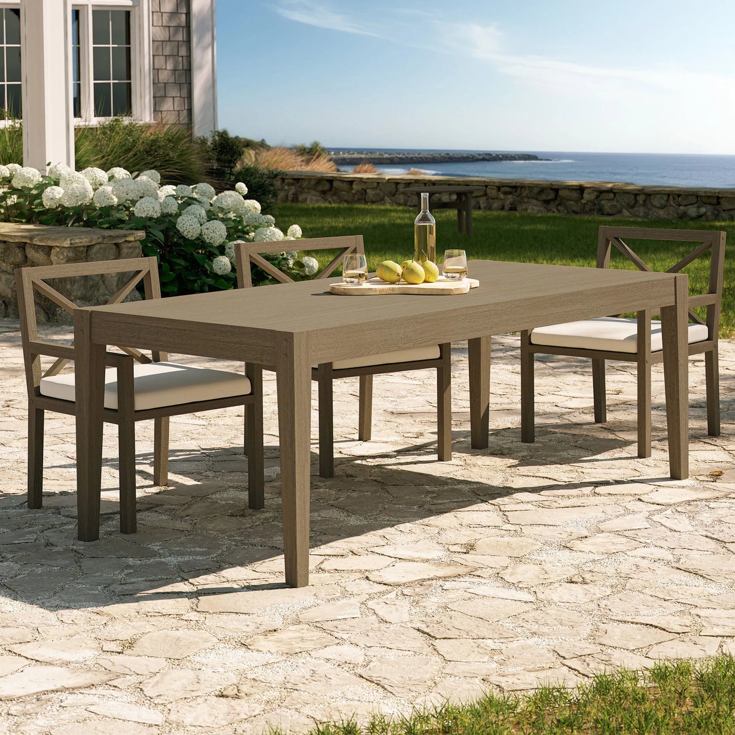 008 SI-2453466 | Lifestyle | Galt 83" Rectangular Teak Dining Table by Evans & Londeen in weathered gray. Made from teak in a modern style.