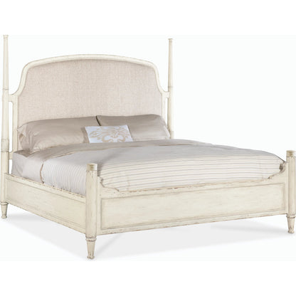 Americana California King Upholstered Poster Bed by Hooker Furniture in beige and worn white. Made from oak veneers and fabric in a traditional style.